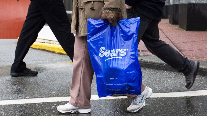 A woman carries a shopping bag while leaving the Sears store in downtown Vancouver, B.C., on Friday, March 2, 2012. (Darryl Dyck / THE CANADIAN PRESS)