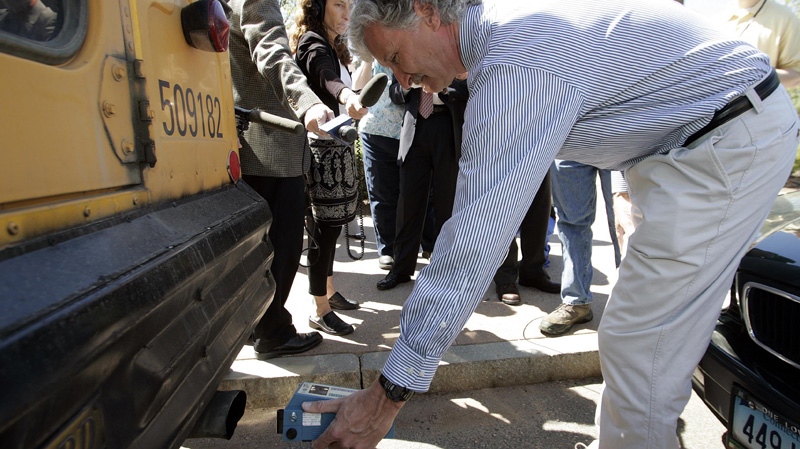 Bruce Hill, Clean Air Task Force Senior Scientist, uses a device to measure the amount of diesel particulate pollution emitted by a school bus lacking pollution control devices on its exhaust system and on its engine during a news conference outside the Legislative Office Building in Hartford, Conn., Tuesday, May 8, 2007. (AP Photo/Bob Child)