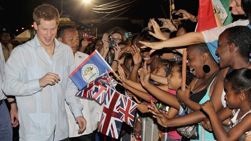 Britain's Prince Harry, left, meets enthusiastic local people during a walkabout at a "block party" in the newly named Queen Elizabeth II Boulevard, in the capital Belmopan, Belize, central America, Friday March 2, 2012. (AP Photo/Chris Jackson, PA)