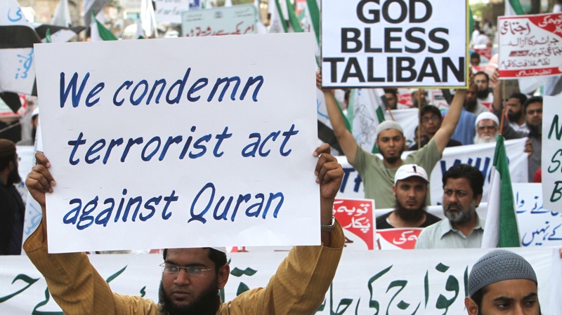 Supporters of a Pakistani religious group Tanzeem-e-Islami hold a rally to condemn the disposal last week of a number of Qurans at a U.S. military base in Afghanistan, in Karachi, Pakistan, Saturday, March 3, 2012. (AP / Fareed Khan)