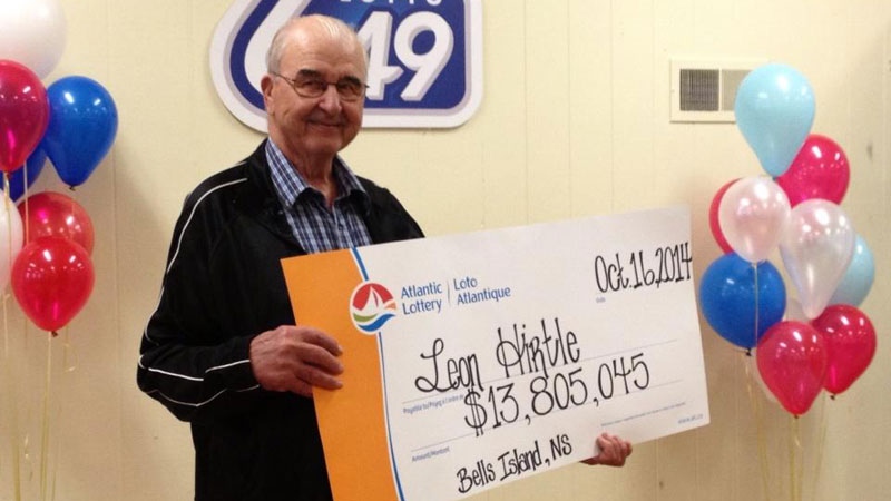 Retired fisherman Leon Hirtle collects a cheque for $13.8 million at the Bridgewater Curling Club Thursday morning.