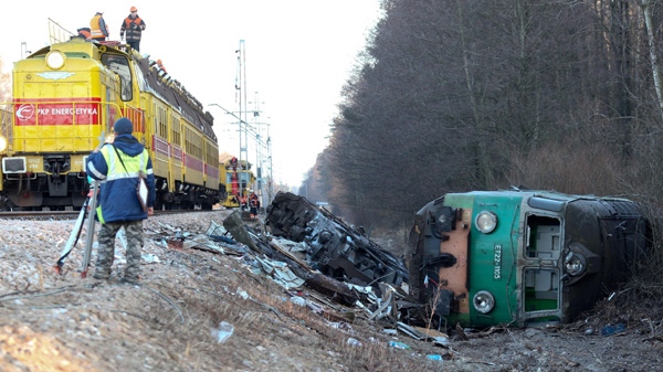 Workers remove debris from the rails, after the Saturday deadly train crash in Szczekociny, Poland, Monday, March 5, 2012. (AP / Wojtek Barczynski) 