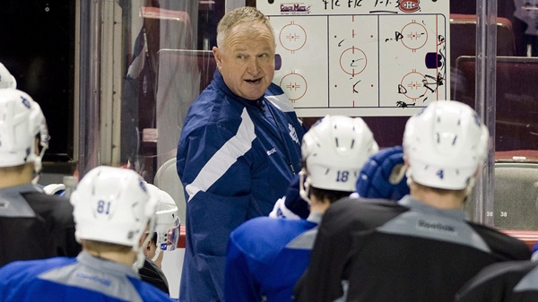 New Toronto Maple Leafs' head coach Randy Carlyle speaks to players during a practice session at the Bell Centre in Montreal, Saturday, March 3, 2012, after his appointment as new head coach of the Toronto Maple Leafs hockey team. THE CANADIAN PRESS/Graham Hughes