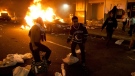 This June 15, 2011 file photo shows Vancouver Canucks hockey fans rioting in downtown Vancouver, Canada following the Vancouver Canucks 4-0 loss to the Boston Bruins in game 7 of the Stanley Cup hockey final.
