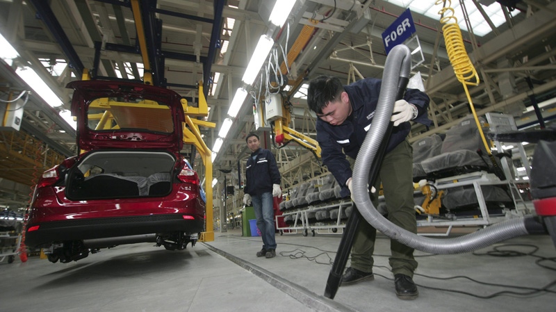 A Chinese worker cleans assembly line of the cars at a newly opened Changan Ford Mazda Automobile (CFMA) Chongqing Plant in Chongqing, China, Friday, Feb. 24, 2012. (AP Photo)