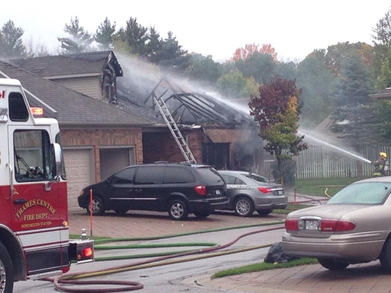 Fire crews deal with a blaze believed to have started in the garage of a home in Dorchester, Ont. on Friday, Oct. 17, 2014. (Gerry Dewan / CTV London)