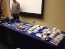 Weapons, cash and drugs seized after searches of two residence are on display in London, Ont. on Friday, Oct. 17, 2014. (Nick Paparella / CTV London)