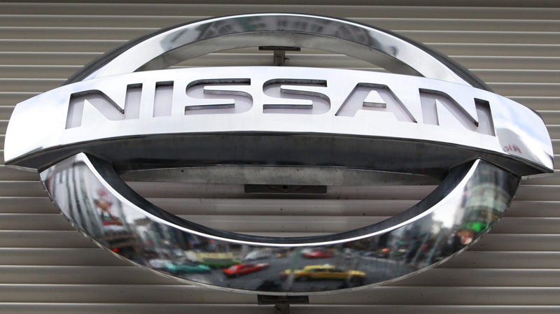 Vehicles are reflected on the logo mark of the Nissan Motors Co. at the company's showroom in Tokyo's Ginza shopping district Wednesday, Feb. 8, 2012. (AP Photo/Shizuo Kambayashi)