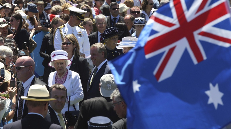 In this Saturday, Oct. 29, 2011 file photo, Queen Elizabeth II, bottom left, walks through the crowd at the Great Aussie Barbecue in Perth, Australia. (AP Photo/Rob Griffith, File)