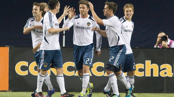 David Beckham (centre) and his L.A. Galaxy team mates celebrate Landon Donovan's equalizing goal during second half action in the CONCACAF Champions League quarter final action against Toronto FC in Toronto on Wednesday March 7, 2012. (THE CANADIAN PRESS/Chris Young)