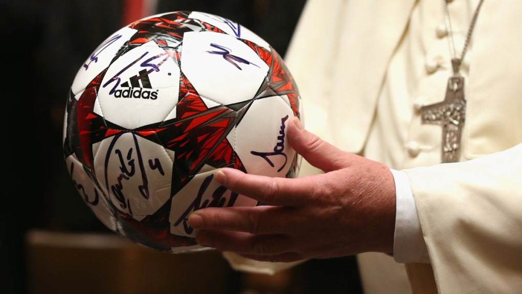 Pope Francis holds an FC Bayern Munich ball