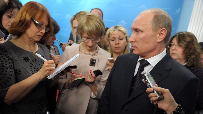 Russian Prime Minister Vladimir Putin, right, speaks during a meeting with reporters in Moscow, Wednesday, March 7, 2012. (AP Photo/RIA-Novosti, Alexei Nikolsky, Government Press Service)