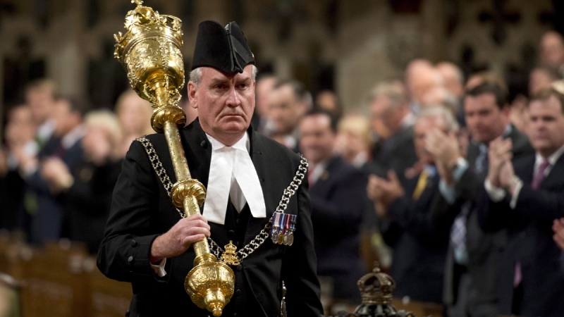The Sergeant-at-Arms Kevin Vickers receives a standing ovation as he enters the House of Commons, in Ottawa, Thursday, Oct. 23, 2014. (Adrian Wyld / THE CANADIAN PRESS)