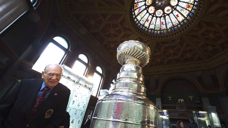 Hockey Hall of Famer Johnny Bower looks for his names on the Stanley Cup after The Hockey Hall of Fame officially unveiled the " Esso Great Wall" as home to the Stanley Cup, all major NHL trophies and recognition structures for individuals elected into Honoured Membership in Toronto on Friday, March. 9, 2012.