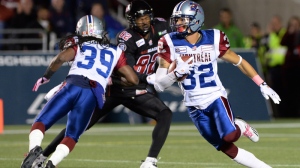 Montreal Alouettes' Mitchell White runs the ball after making an interception against the Ottawa Redblacks during CFL action in Ottawa on Friday Oct 24, 2014. THE CANADIAN PRESS/Sean Kilpatrick