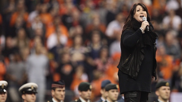 Jann Arden performs the national anthem during pre-game ceremonies before the B.C. Lions meet the Winnipeg Blue Bombers at the 99th CFL Grey Cup in Vancouver, on Sunday, November 27, 2011. (Darryl Dyck / THE CANADIAN PRESS)