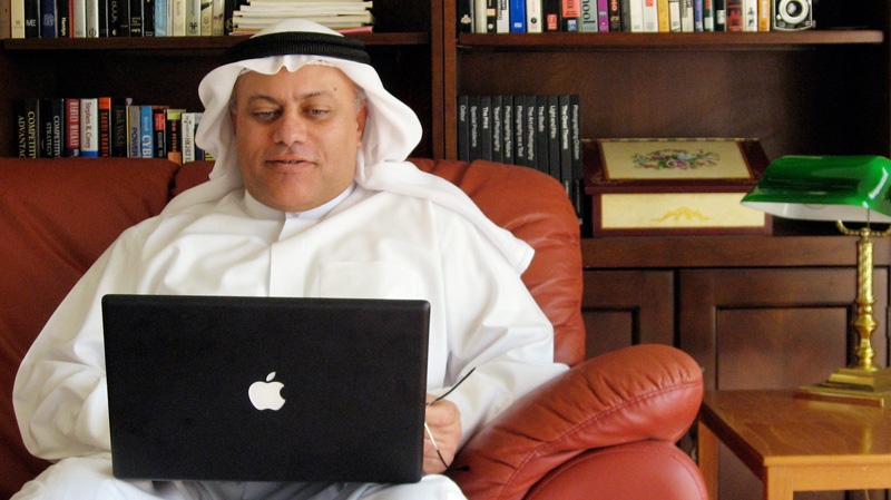 In this photo released by the subject, Bahraini blogger Mahmood al-Yousif works on his laptop at his house in Manama, Bahrain Tuesday, Nov. 21, 2006. (AP Photo/Courtesy Mahmood al-Yousif )