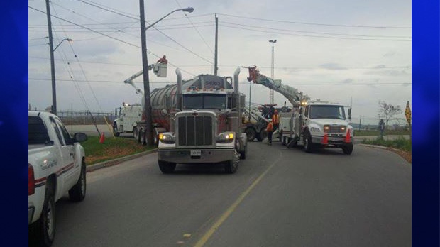 Crews work at the scene of a crash between a tanker truck and a hydro pole in Woodstock, Ont., in this picture the Woodstock Police Service posted to its Facebook page.