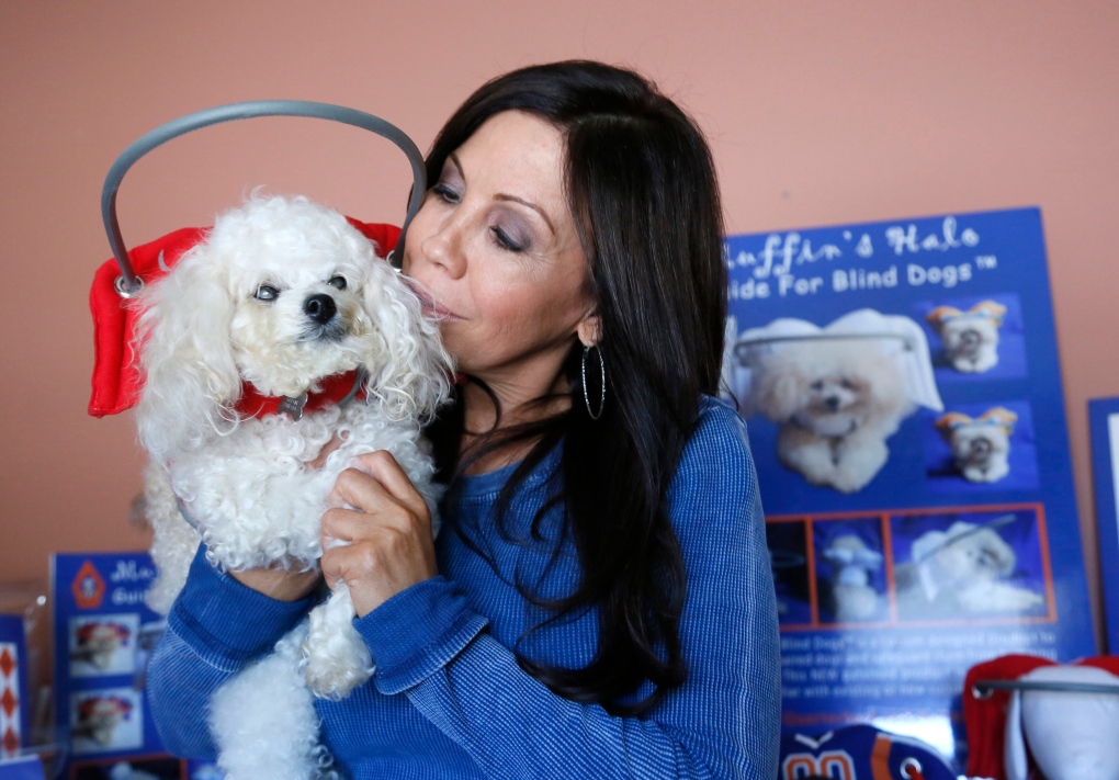 Silvie Bordeaux holds her blind dog Muffin