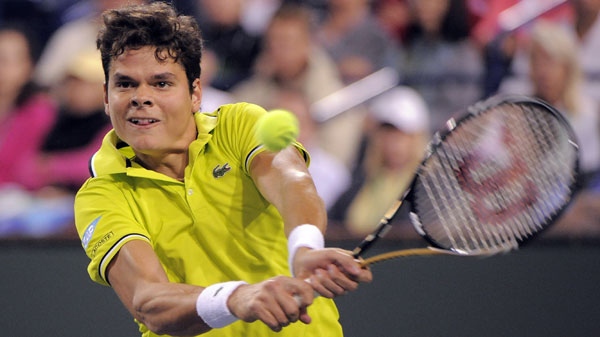 Milos Raonic, of Canada, returns a shot to Roger Federer, of Switzerland, at the BNP Paribas Open tennis tournament, Tuesday, March 13, 2012, in Indian Wells, Calif. (AP Photo/Mark J. Terrill) 