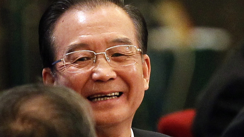 Chinese Premier Wen Jiabao reacts at the end of a press conference held after the closing session of the annual National People's Congress in the Great Hall of the People, in Beijing, China, Wednesday, March 14, 2012. (AP Photo/Ng Han Guan)