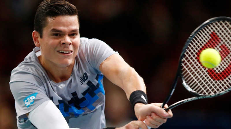 Milos Raonic of Canada returns the ball to Roger F