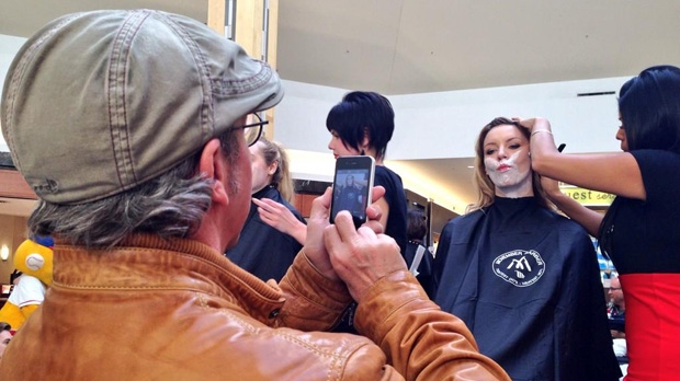 Radio personality Heather Prosak of BOB FM gets a mock Movember shave as colleague Beau takes a picture. (Photo by Ben Miljure/CTV)