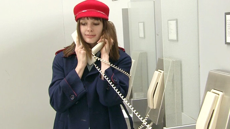 A passenger tries to rebook her flight using an Air Canada courtesy phone at Pearson International Airport on Sunday, March 18, 2012.