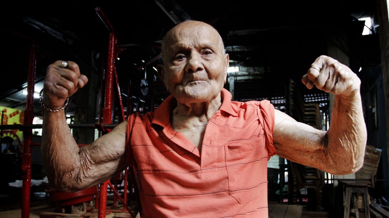 In this Friday, March 16, 2012 photo, Indian body builder Manohar Aich flexes his muscles as he poses for a photograph in a gymnasium in Kolkata, India. (AP Photo/Bikas Das)
