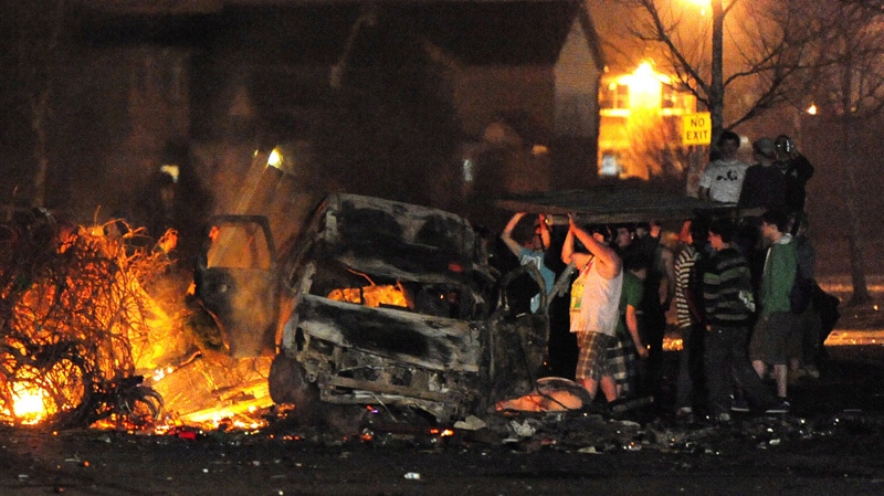 Rioters add more fuel to a fire during a riot in London, Ont., early Sunday, March 18, 2012. (Mike Maloney  / London Community News)