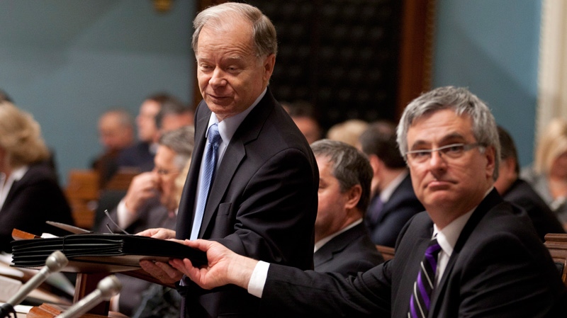 Quebec Finance Minister Raymond Bachand, left, tables the budget documents Tuesday, March 20, 2012 at the legislature in Quebec City.(Jacques Boissinot / THE CANADIAN PRESS)