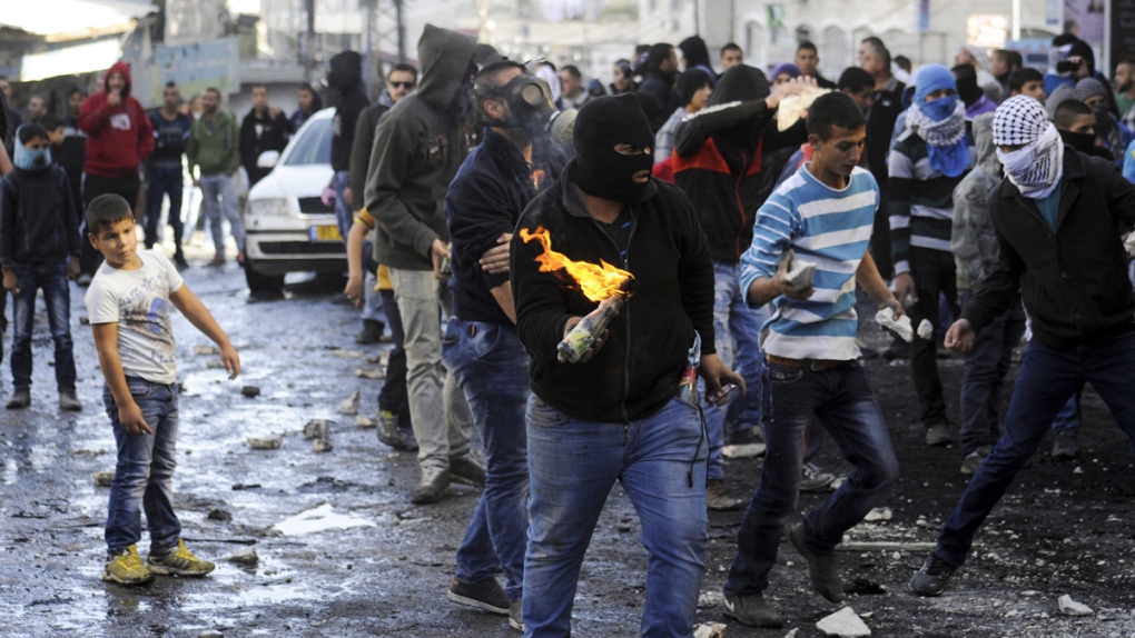 Palestinian holds a molotov cocktail in Jerusalem