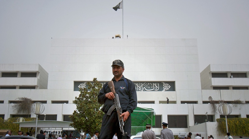 A Pakistani police commando stands guard at Parliament House in Islamabad, Pakistan on Tuesday, March 20, 2012. (AP Photo/Anjum Naveed)