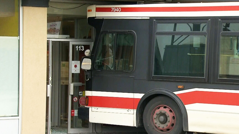 A TTC bus sits in the entrance to a bank branch where it was involved in a fatal collision Sunday, Nov. 9, 2014.
