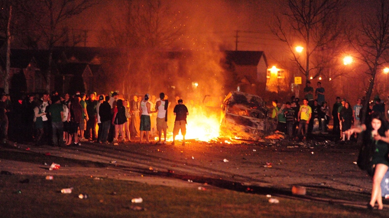 A vehicle burns during a riot on London, Ont., in the early hours of Sunday, March 18, 2012. (THE CANADIAN PRESS/London Community News-Mike Maloney)