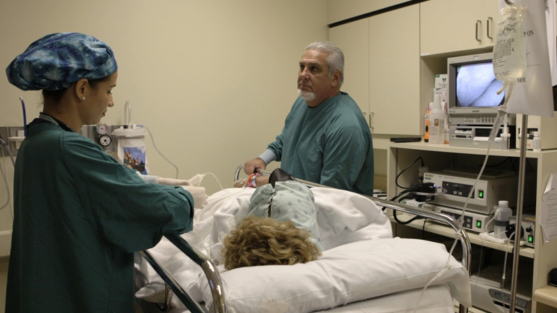This Aug. 26, 2009 photo shows Dr. Pedro Jose Greer, right, preparing to do a colonoscopy at Mercy Hospital in Miami, Florida. (AP Photo/Lynne Sladky)