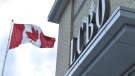 A Canadian flag flies near an under-construction LCBO store in Bowmanville, Ont. on Saturday, July 20, 2013. (File / THE CANADIAN PRESS)