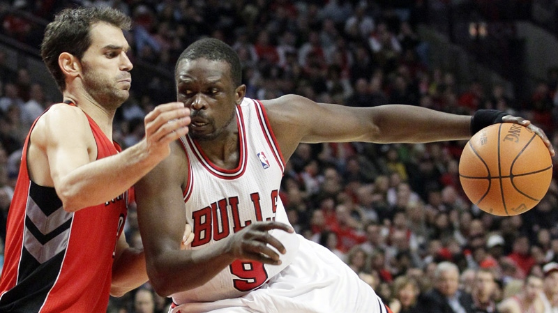 Chicago Bulls forward Luol Deng (9) drives to the basket as Toronto Raptors guard Jose Calderon (8) during the second half of an NBA basketball game in Chicago, Saturday, March 24, 2012. The Bulls won 102-101.