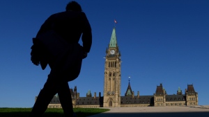 FILE - A man walks on Parliament Hill on September 15, 2014.  (Sean Kilpatrick/THE CANADIAN PRESS)