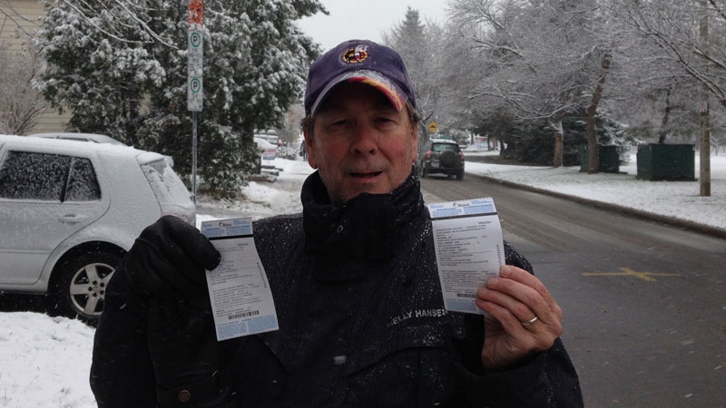 Tim McCarthy shows the two $55 tickets he received for parking his second vehicle in front of his house near Lansdowne Park. (Photo: Jeff Dorn/CTV Ottawa)