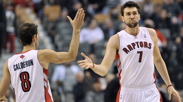 Toronto Raptors teammates Jose Calderon, left, and Andrea Bargnani, right, celebrate a basket while playing against the Denver Nuggets during first half NBA basketball action in Toronto on Wednesday, March 28, 2012. THE CANADIAN PRESS/Nathan Denette
