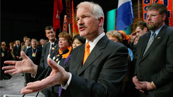 Newly-elected federal NDP Leader Jack Layton of Toronto (centre) speaks to delegates after winning on the first ballot at the party's convention in Toronto on Saturday, January 25, 2003. (Kevin Frayer / THE CANADIAN PRESS)