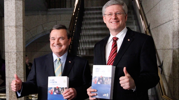Finance Minister Jim Flaherty and Prime Minister Stephen Harper make their way to the House of Commons to deliver the federal budget on Parliament Hill in Ottawa on Thursday March 29, 2011. (Fred Chartrand / THE CANADIAN PRESS)