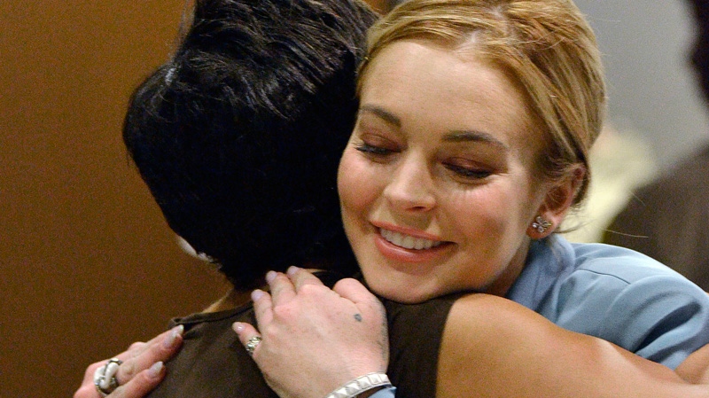 Lindsay Lohan, right, embraces her attorney, Shawn Chapman Holley after a progress report on her probation for theft charges at Los Angeles Superior Court Thursday, March 29, 2012.  (AP / Joe Klamar)