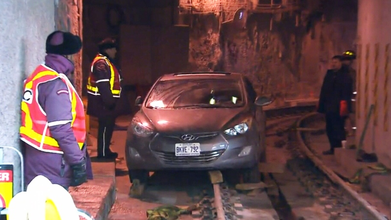 Emergency crews worked to remove a vehicle that was lodged on the tracks in a streetcar tunnel to Union Station, on Saturday, Nov. 22, 2013.