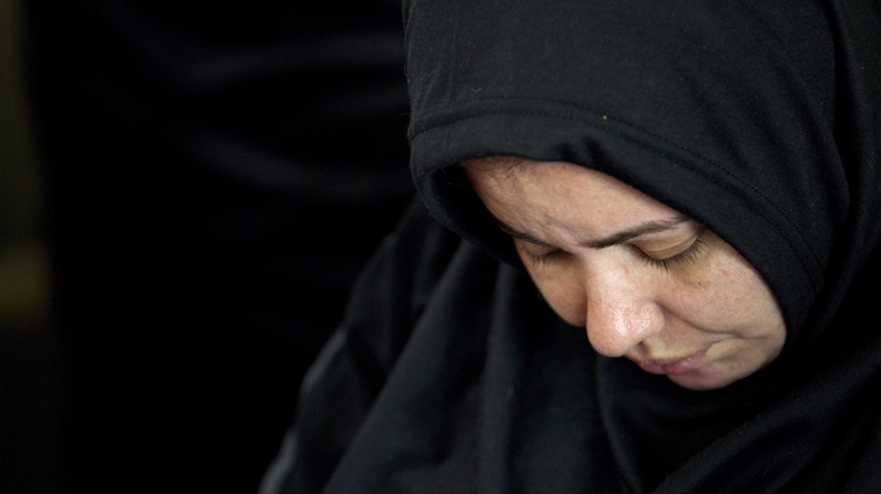 A woman bows her head during a memorial for Shaima Alawadi at a mosque Tuesday, March 27, 2012, in Lakeside, Calif. 