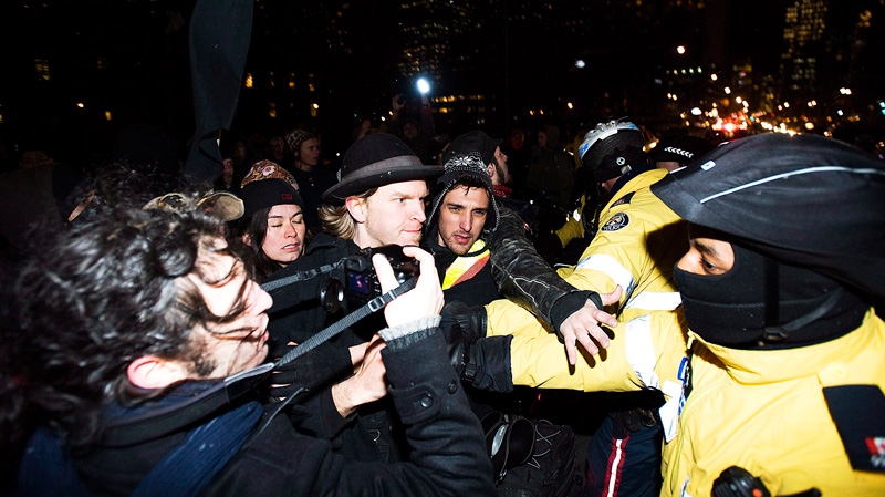 Occupy Toronto protesters clash with police while they march north on University Ave. in Toronto on Friday March 30, 2012.