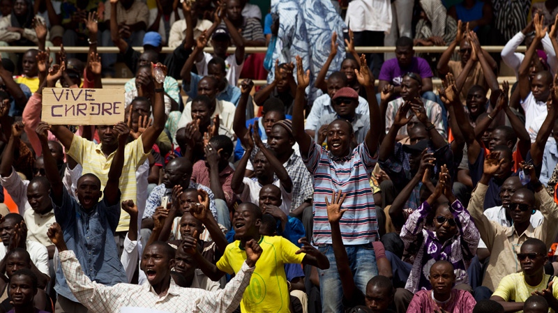 People cheer during a rally in support of the ruling military junta, attended by roughly one thousand people in a stadium with a capacity of 50,000, in Bamako, Ma