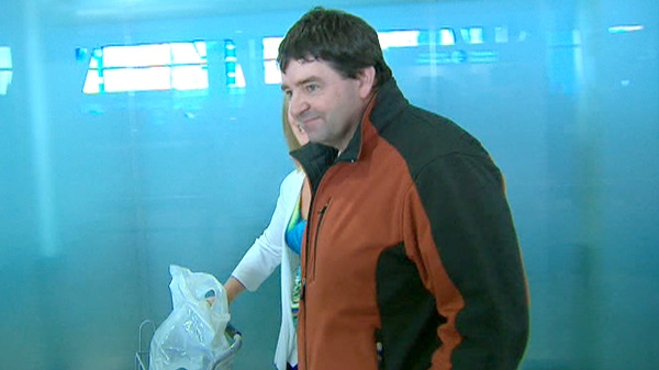 New Brunswick potato farmer Henk Tepper walks with his sister Harmien Dionne as he arrives at the airport in Ottawa, Saturday March 31, 2012.