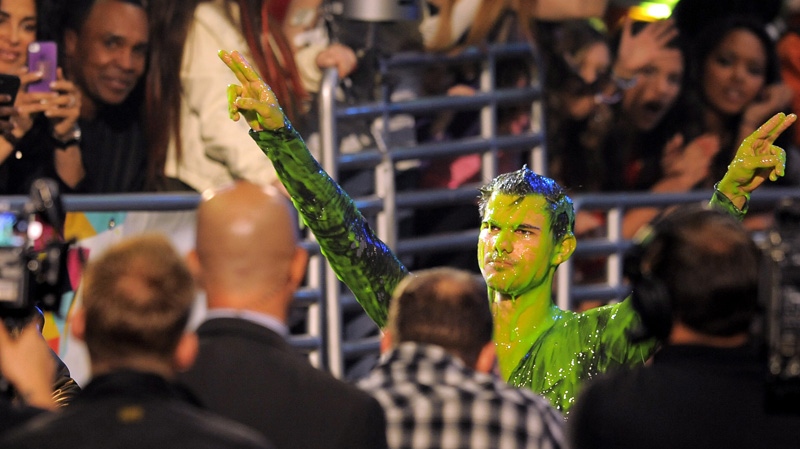 Taylor Lautner gets slimed after accepting the award for favorite buttkicker at Nickelodeon's 25th Annual Kids' Choice Awards on Saturday, March 31, 2012 in Los Angeles. (AP Photo/Chris Pizzello)